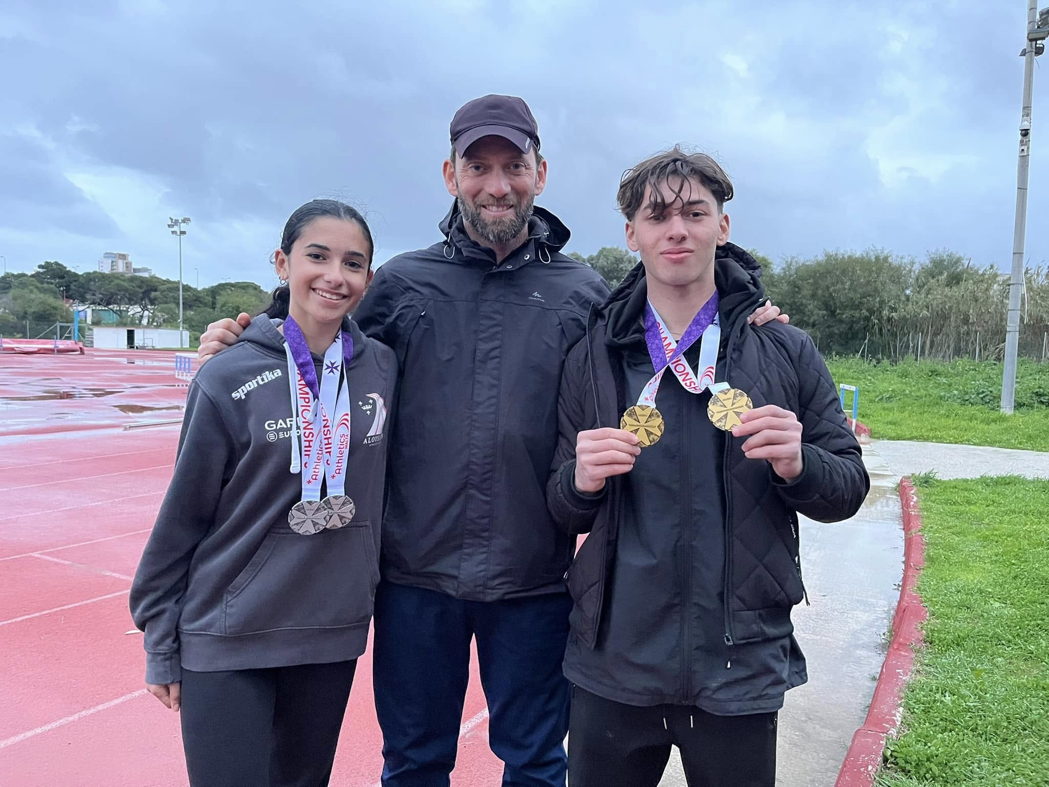 Coach Edward Grech (centre) together with Raquela Calleja (left) and Andrea Grech. Photo: James Azzopardi/Athletics Malta